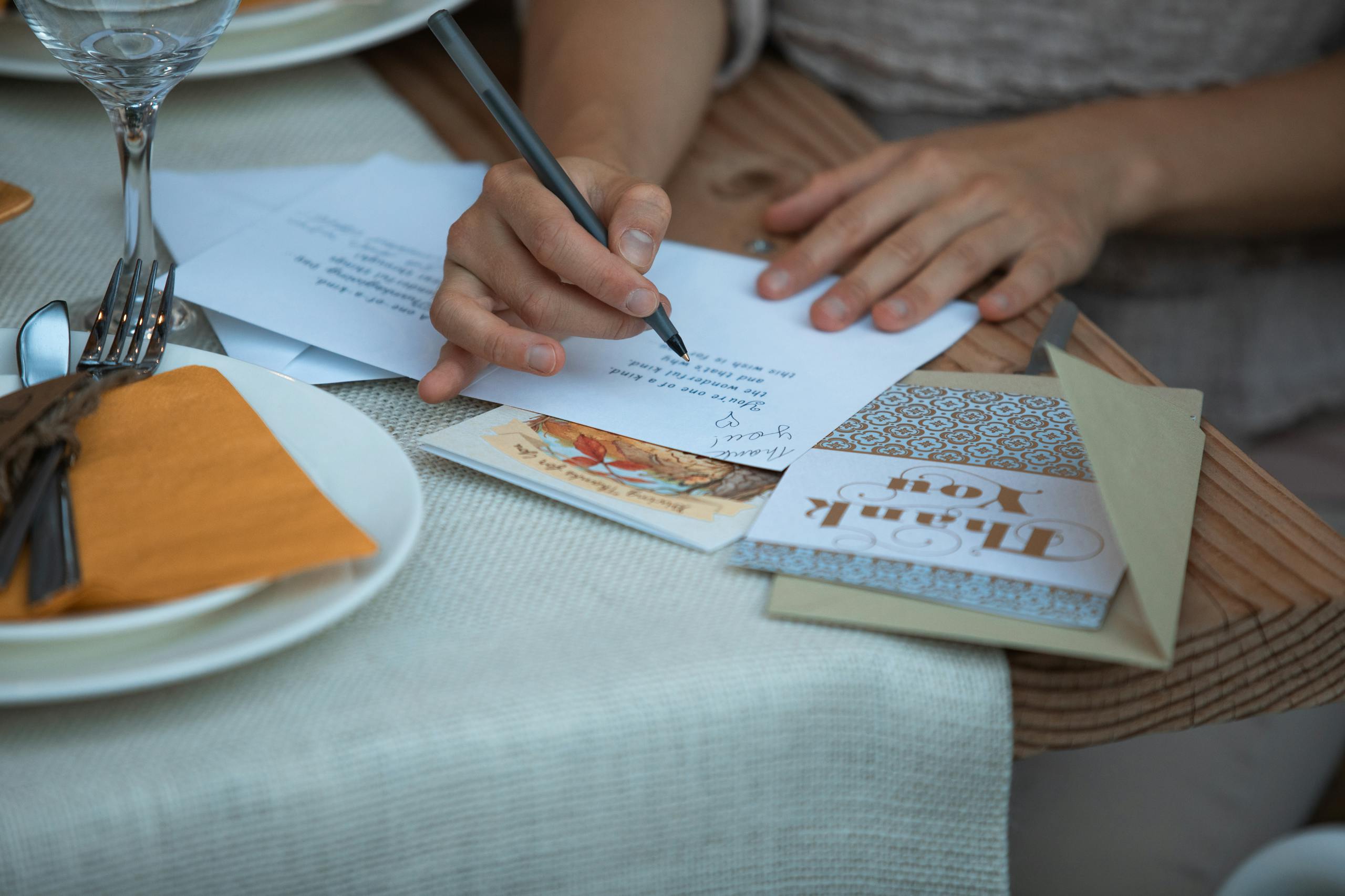 Person Writing on White Paper